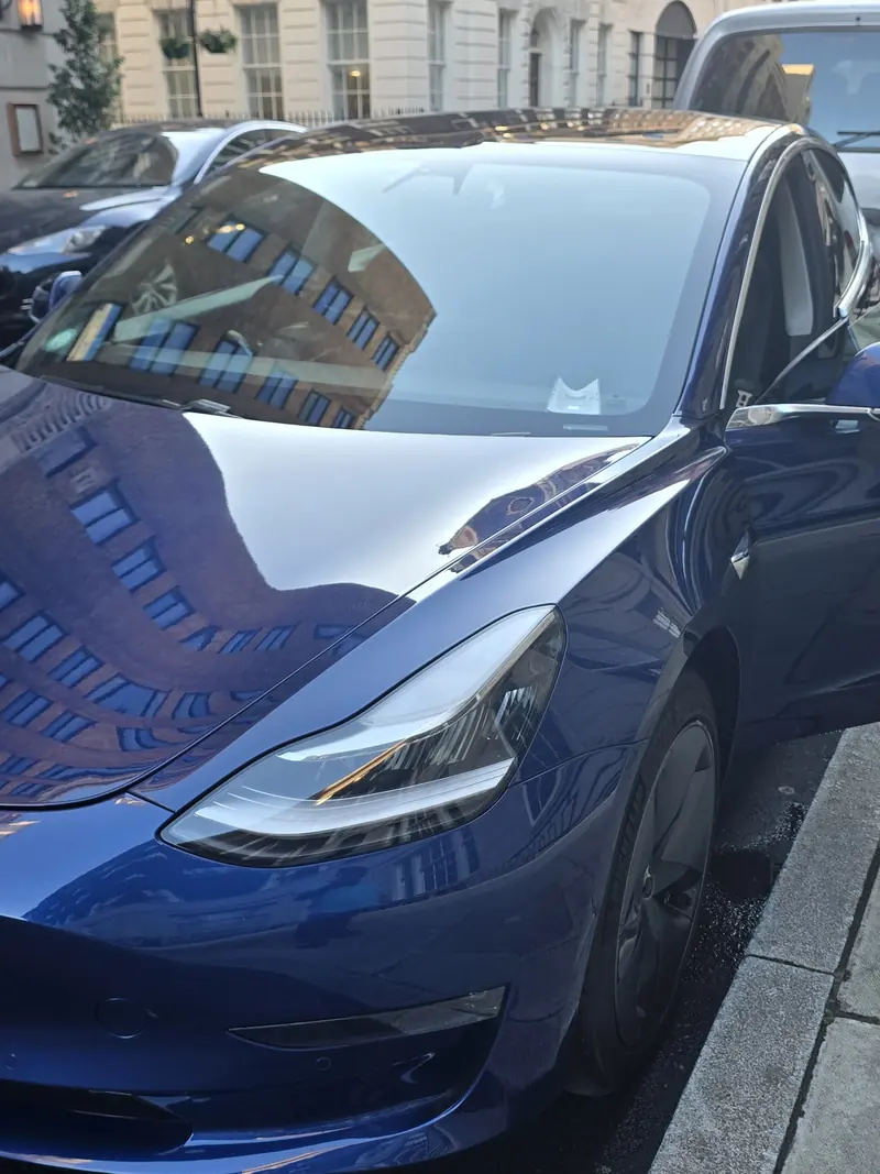 Blue Tesla with glossy paintwork photographed after a client detail